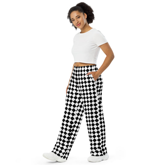 Black and white checkered lounge pants with a loose, wide-leg fit. The pants are crafted from a soft and cozy fabric that is perfect for lounging or sleeping. They feature a high waistband with a drawstring for a comfortable and adjustable fit. The checkered pattern is bold and eye-catching, while the wide-leg design adds a touch of retro-inspired style. These lounge pants are perfect for relaxing at home or running quick errands in comfort and style