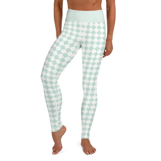 A pair of leggings with a pattern of green and white squares in a chequered design. The leggings are form-fitting and stretchy, with the squares appearing evenly spaced across the entire surface. The color green is a bright and vivid shade, while the white squares provide contrast and balance. The leggings appear to be made from a comfortable and durable material, suitable for a range of activities from workouts to casual wear.